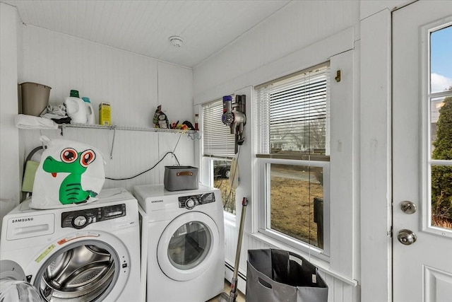 laundry area with washer and clothes dryer, laundry area, and a baseboard heating unit