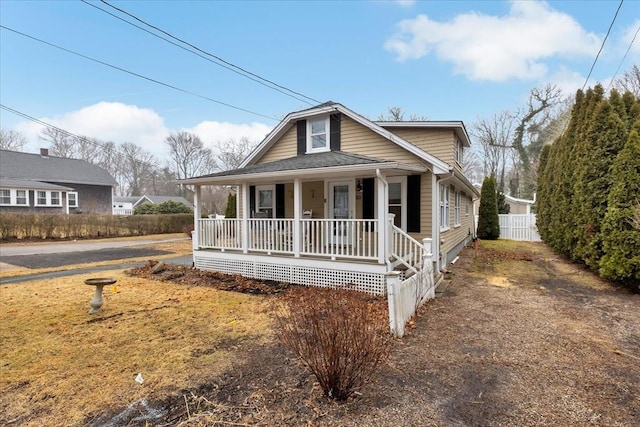 view of front of house with a porch and fence