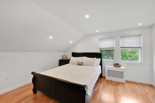 bedroom featuring radiator heating unit, light wood-type flooring, lofted ceiling, recessed lighting, and baseboards