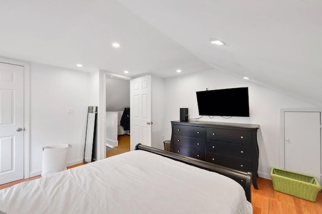bedroom with wood finished floors, lofted ceiling, recessed lighting, and baseboards
