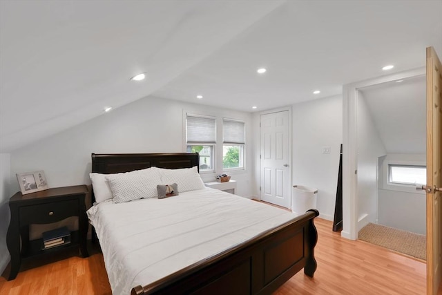 bedroom featuring lofted ceiling, light wood-type flooring, recessed lighting, and a closet