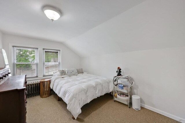 bedroom featuring radiator heating unit, lofted ceiling, light colored carpet, and baseboards