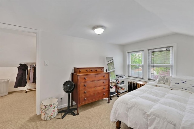 bedroom featuring carpet floors, lofted ceiling, and radiator