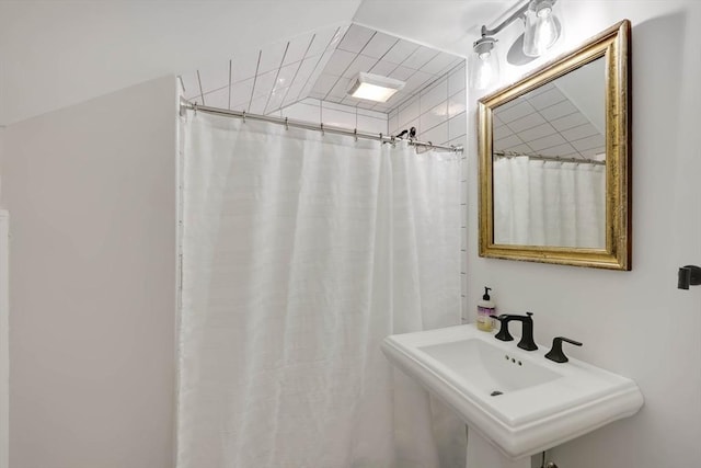 bathroom with a sink and a shower with shower curtain