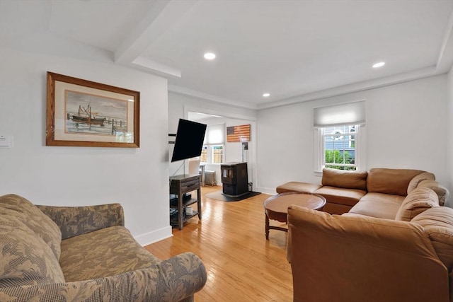 living area with recessed lighting, light wood finished floors, a wood stove, and baseboards