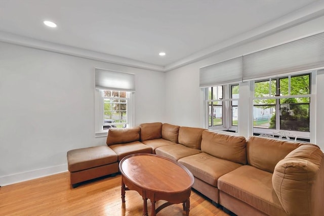 living room featuring light wood-type flooring, baseboards, and recessed lighting