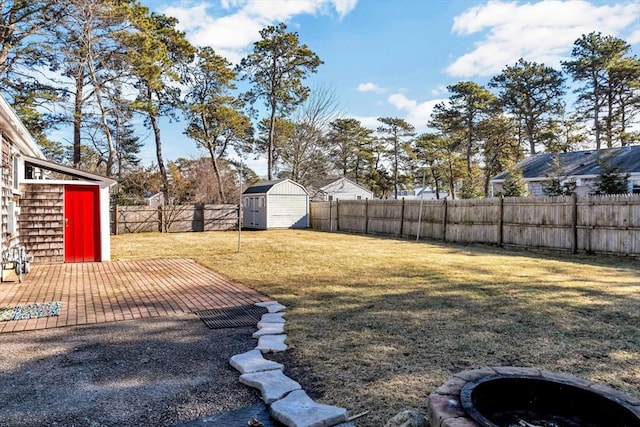 view of yard with a storage shed and a patio area