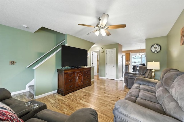 50 Waters Edge Unit 50, Ludlow, MA 01056 - living area featuring stairs, a ceiling fan, light wood-style flooring, and a chandelier