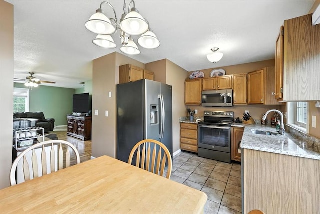 50 Waters Edge Unit 50, Ludlow, MA 01056 - kitchen with appliances with stainless steel finishes, ceiling fan, open floor plan, a chandelier, and light tile patterned floors