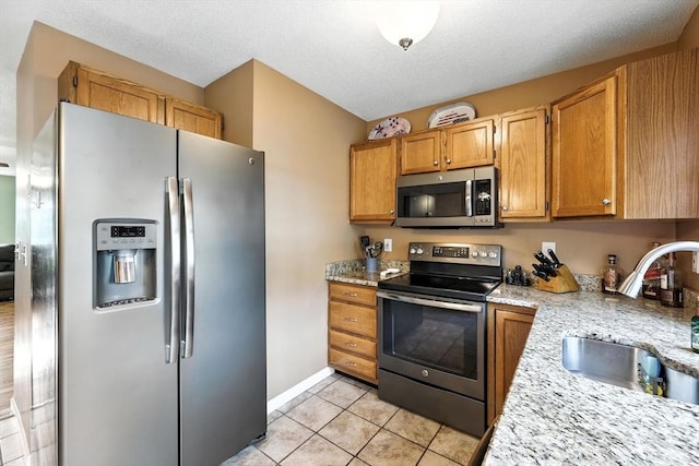 50 Waters Edge Unit 50, Ludlow, MA 01056 - kitchen featuring appliances with stainless steel finishes and light tile patterned floors