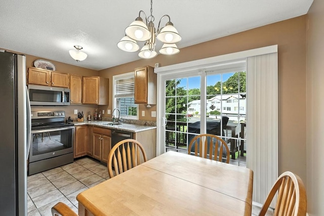 50 Waters Edge Unit 50, Ludlow, MA 01056 - kitchen with appliances with stainless steel finishes, a chandelier, light countertops, and light tile patterned floors