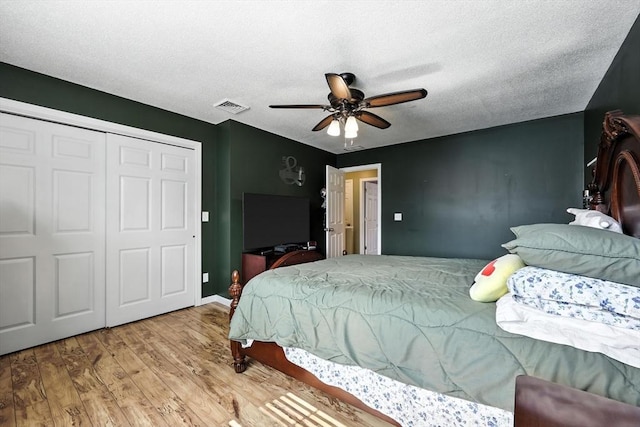 50 Waters Edge Unit 50, Ludlow, MA 01056 - bedroom featuring wood finished floors, a closet, a textured ceiling, and a ceiling fan
