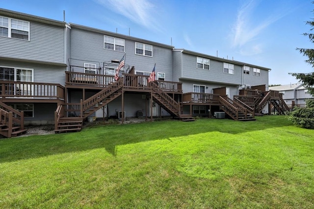 50 Waters Edge Unit 50, Ludlow, MA 01056 - back of house with stairs, a wooden deck, and a lawn