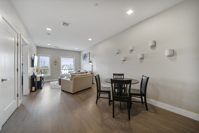 dining space featuring dark wood-type flooring