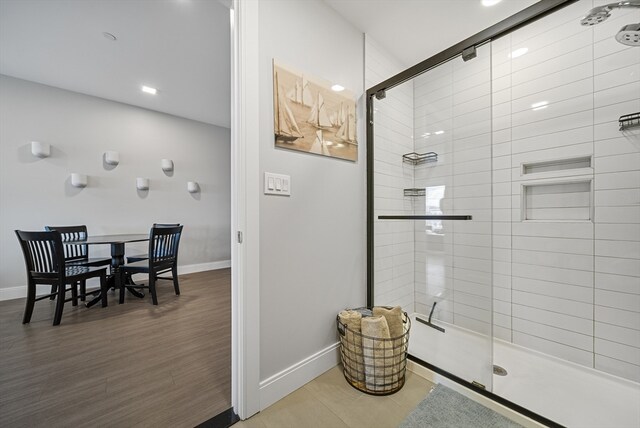 bathroom with wood-type flooring and walk in shower