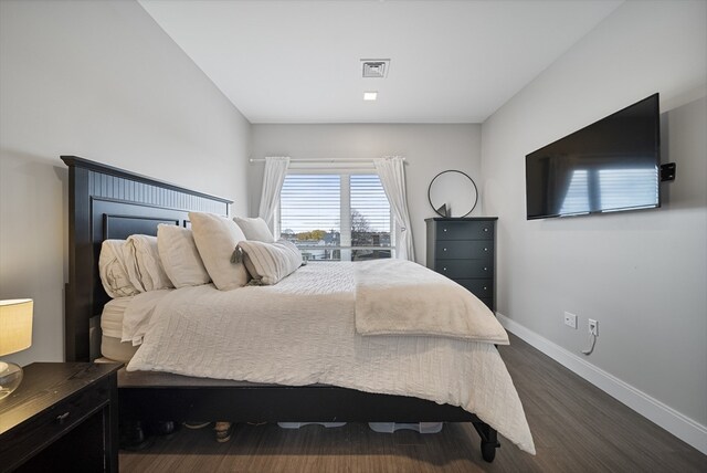 bedroom with dark hardwood / wood-style floors