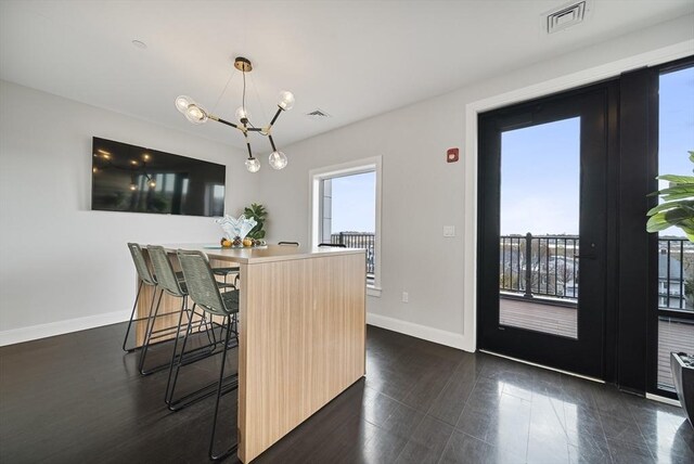11 Walley St Unit 202, Boston, MA 02128 - dining area with plenty of natural light, baseboards, and a chandelier