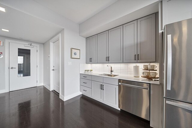 11 Walley St Unit 202, Boston, MA 02128 - kitchen with appliances with stainless steel finishes, a sink, gray cabinetry, baseboards, and light countertops