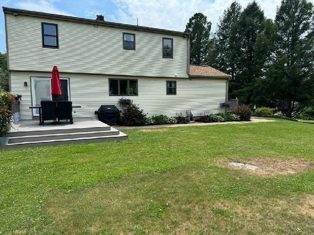 rear view of house with a yard and a deck