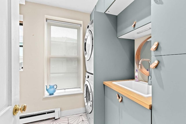 46A Cedar St Unit 2, Boston, MA 02119 - washroom with a baseboard heating unit, stacked washer / dryer, and cabinet space