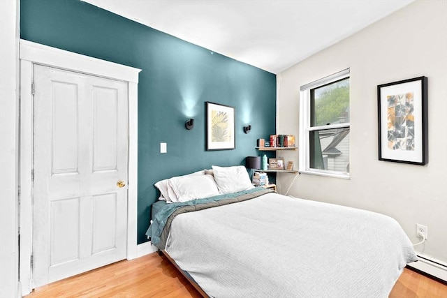 46A Cedar St Unit 2, Boston, MA 02119 - bedroom featuring a baseboard radiator, light wood-style floors, and baseboards