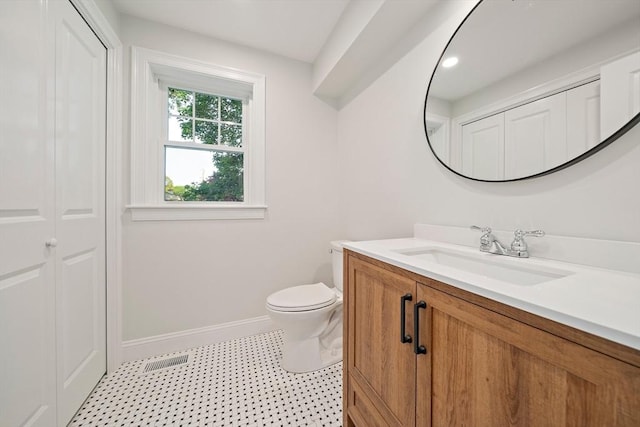 56 Lake St, Braintree, MA 02184 - bathroom with baseboards, vanity, toilet, and a closet