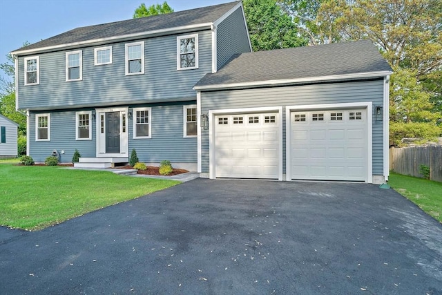 56 Lake St, Braintree, MA 02184 - colonial-style house with an attached garage and asphalt driveway