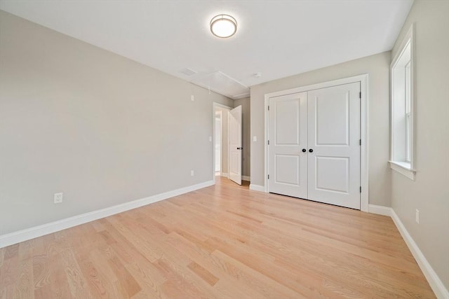 56 Lake St, Braintree, MA 02184 - unfurnished bedroom with attic access, light wood finished floors, baseboards, and a closet