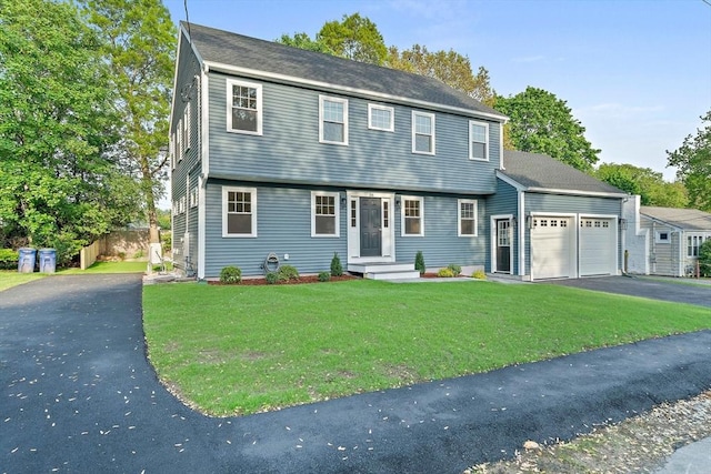 56 Lake St, Braintree, MA 02184 - colonial house featuring asphalt driveway and a garage