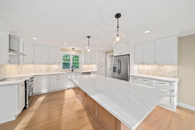 56 Lake St, Braintree, MA 02184 - kitchen with appliances with stainless steel finishes, a spacious island, light wood-style floors, tasteful backsplash, and recessed lighting