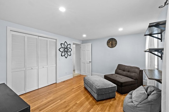 sitting room with wood-type flooring