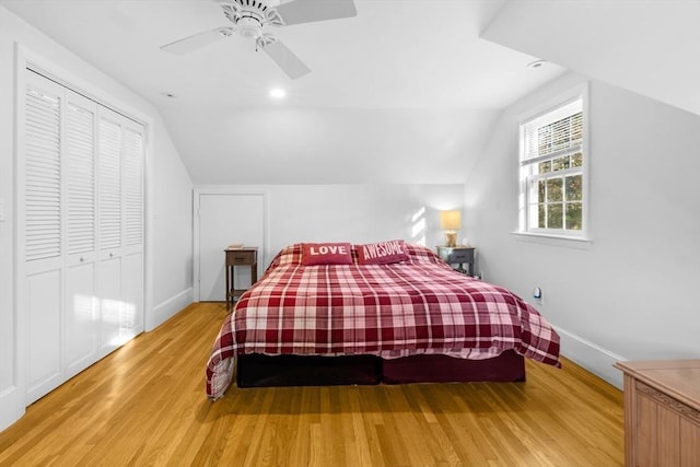 bedroom with wood-type flooring, vaulted ceiling, a closet, and ceiling fan