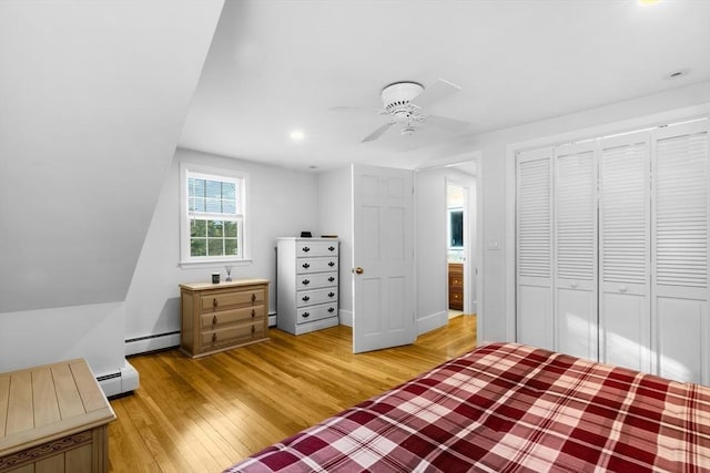 unfurnished bedroom with a baseboard radiator, light hardwood / wood-style floors, a closet, and ceiling fan