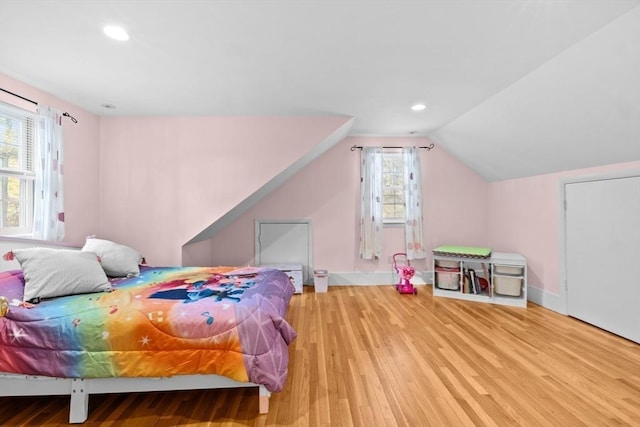 bedroom featuring vaulted ceiling and light hardwood / wood-style floors