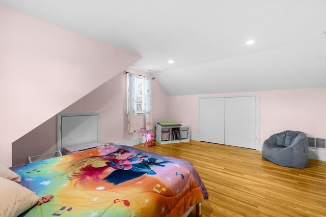 bedroom featuring vaulted ceiling and light hardwood / wood-style floors