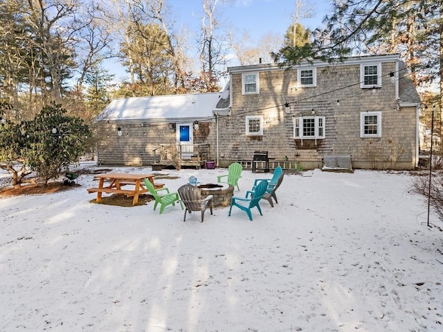 snow covered property featuring a fire pit