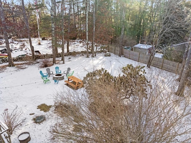 snowy yard featuring a fire pit