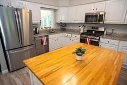 185 Baldwinville Rd, Winchendon, MA 01475 - kitchen featuring stainless steel appliances, butcher block countertops, white cabinets, and wood finished floors