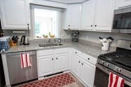 185 Baldwinville Rd, Winchendon, MA 01475 - kitchen with appliances with stainless steel finishes, white cabinetry, light countertops, and a sink