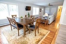 185 Baldwinville Rd, Winchendon, MA 01475 - dining room featuring plenty of natural light, wood finished floors, ceiling fan, and a baseboard heating unit