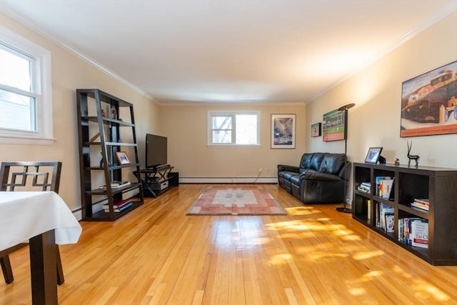 living area featuring baseboard heating, wood finished floors, and ornamental molding