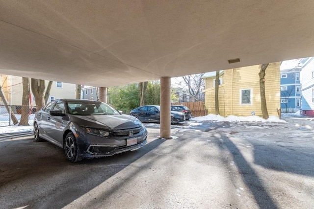 partially covered parking lot with fence