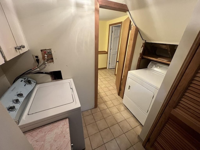 18 Blueberry Ln, Barnstable, MA 02648 - washroom featuring washing machine and clothes dryer, cabinet space, and light tile patterned flooring