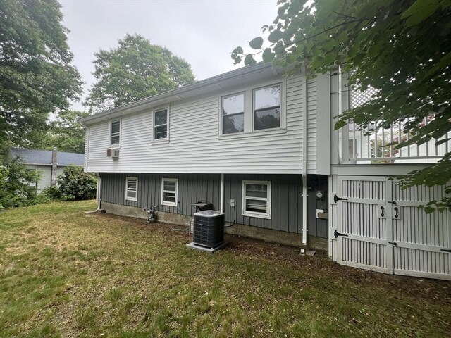 18 Blueberry Ln, Barnstable, MA 02648 - back of property featuring board and batten siding, a lawn, and a gate