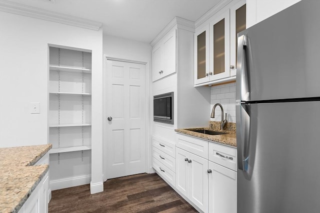 35 Des Moines Rd Unit 310, Quincy, MA 02169 - kitchen with freestanding refrigerator, built in microwave, dark wood-style flooring, glass insert cabinets, and light stone countertops