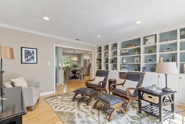 9 Bateson Dr, Andover, MA 01810 - living area featuring light wood-style floors, ornamental molding, baseboards, recessed lighting, and built in features