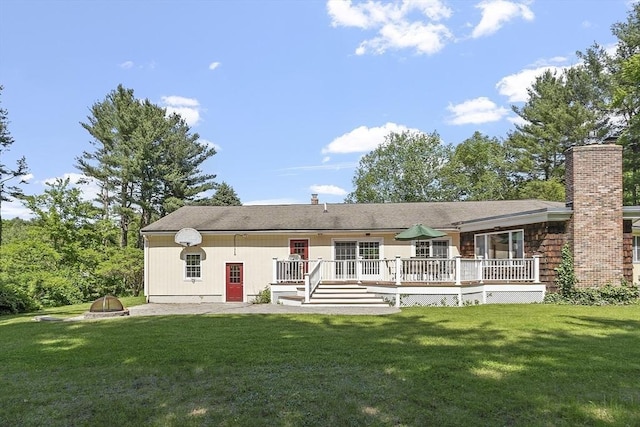 9 Bateson Dr, Andover, MA 01810 - back of house with a chimney, a deck, and a yard