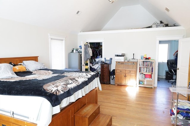 bedroom featuring vaulted ceiling and light hardwood / wood-style flooring