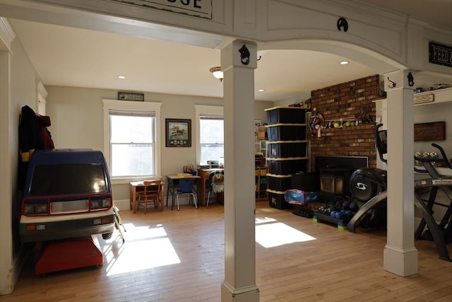 living room featuring decorative columns and light hardwood / wood-style flooring