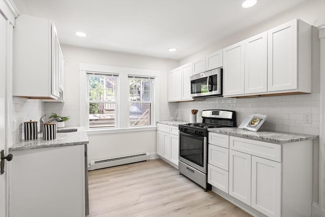 3 Regent Cir Unit 3, Boston, MA 02130 - kitchen with stainless steel appliances, a baseboard heating unit, white cabinets, light wood-style floors, and recessed lighting